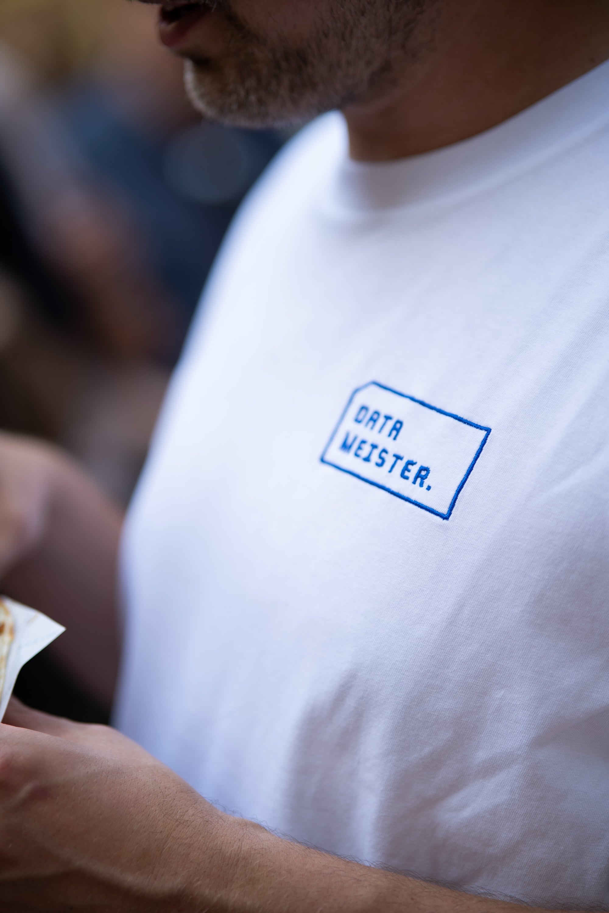 Close-up of a Datameister-branded t-shirt with the embroidered logo at a team event